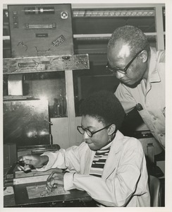 Leroy Milbedge oversees Cynthia Richardsen at TOWER electronics assembly training