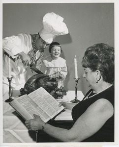 Chef Michael Malone and Leslee Trimble with turkey and woman reading bible