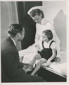 Doctor and nurse examining young girl with cerebral palsy