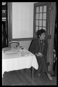 Woman seated at a table at a reception for Jesse Jackson