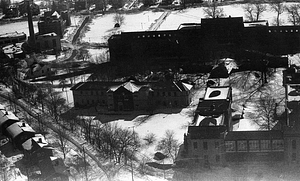 Aerial view of snowy fields and buildings