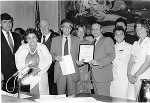 Boston City Councilors Joseph M. Tierney and James M. Kelly with other members of Boston City Council presenting an official resolution to an unidentified group in Boston City Hall