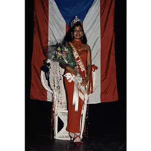 The queen of the Festival Puertorriqueño poses with a bouquet of flowers