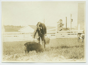 Booker T. Washington with a pig