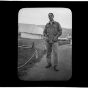 Portrait of man in front of camp