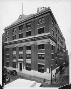 Exterior of Suffolk University's Archer Building (20 Derne Street), showing the electric sign on the roof