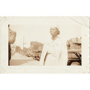 Inez Irving Hunter stands on a sidewalk