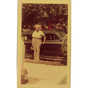 Reverend Dr. Wm. Frederick Fisher leans against the door of a car