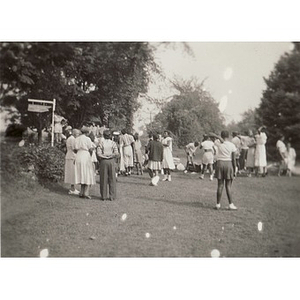A group of people gather on the lawn at Breezy Meadows Camp