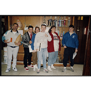 Six staff members posing in front of a display case