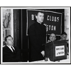 A priest speaking at the podium during a Boys' Clubs of Boston awards event