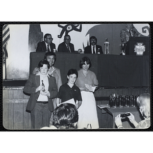 A man and a woman stand with two boys holding their awards during a Boys' Clubs of Boston Awards Night