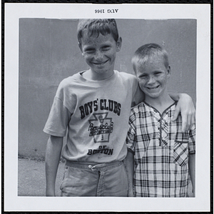 Two boys smiling for the camera with their arm around at a Boys' Club Freckle King Contest