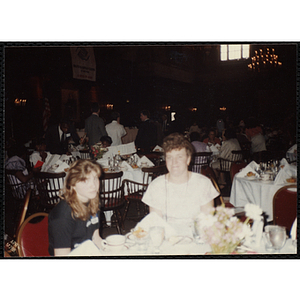 A woman and a girl, seated at a table, pose for the camera at the "Recognition Dinner at Harvard Club"