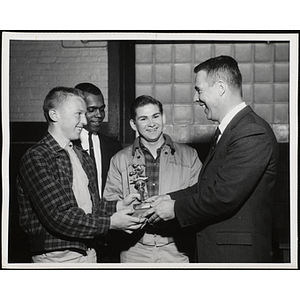 Two young men receive a trophy in the 40th Boys' Clubs of Boston Basketball Tournament