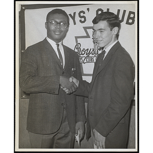 "Boy of the Year, Collins Baker," shakes hands with an unidentified young man