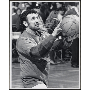Boston radio personality Charles Laquidara holding a basketball as if shooting at a fund-raising event held by the Boys and Girls Clubs of Boston and Boston Celtics