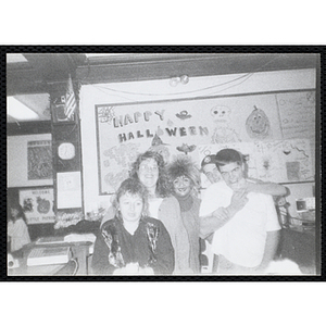 Five teenagers pose for a group shot at a Halloween event