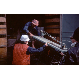 Men load furniture into a truck