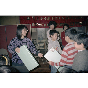 Children passing around their gifts at the Garment Workers' Center