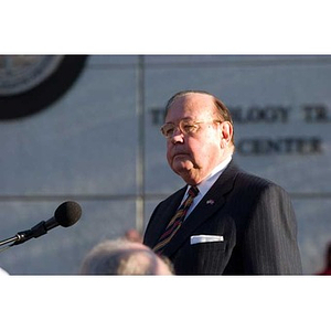 Richard Egan stands at the microphone at the Veterans Memorial dedication