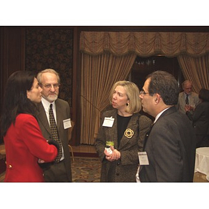 Four people standing before the gala dinner to honor John Hatsopoulos