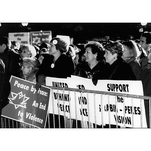 People holding signs in support of Rabin