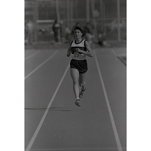 A woman on the Northeastern track team runs at Harvard