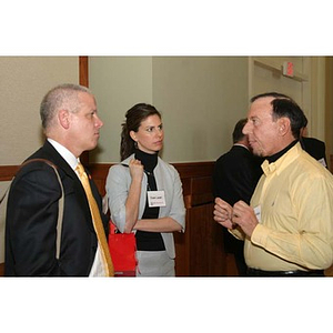 Two men and a woman converse at the Training Future Innovators Entrepreneurs Panel