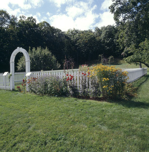 View of fenced garden showing entrance arch, summer, Barrett House, New Ipswich, N.H.