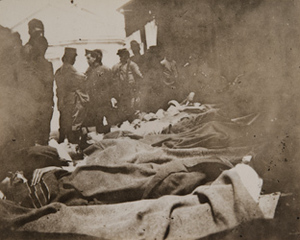 Wounded soldiers on stretchers on a train platform