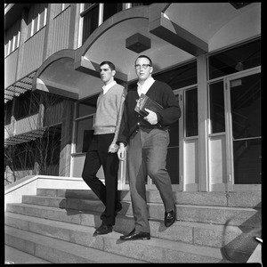 Greg Landry (quarterback, left) and Jim Mitchell (tackle), UMass Amherst football co-captains for 1967-1968, walking down the steps of Boyden Gymnasium