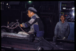 Shanghai tractor building factory: workers operating machines