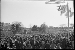 Crowd of demonstrators under American flags on the National Mall, Jefferson Memorial in the distance: Washington Vietnam March for Peace