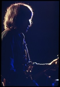John Fogerty in profile, performing on with Creedence Clearwater Revival at the Woodstock Festival