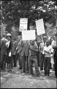 Young protesters holding signs demanding racial equality and fair employment in Washington, D.C.