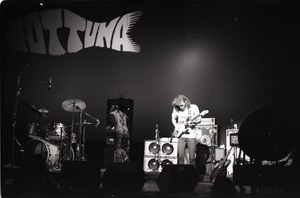 Hot Tuna concert: Band in performance on stage, Jorma Kaukonen (guitar) with "Hot Tuna" in lights behind