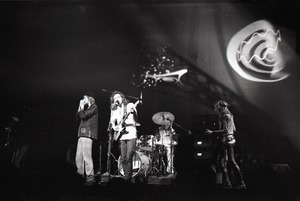 Hot Tuna concert: Band in performance on stage: Will Scarlett (harmonica), Jorma Kaukonen (guitar), Jack Casady (bass) playing in front of light show