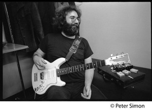Jerry Garcia: half-length portrait playing guitar