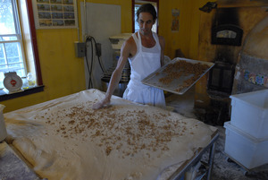 Hungry Ghost Bread: owner and baker Jonathan C. Stevens spreading filling dough for cinnamon rolls