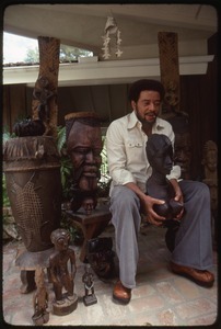 Bill Withers: Withers surrounded by African sculpture and cupping the breasts of a bust