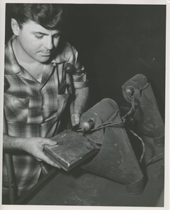 ICD trainee William DeMarshe polishes the metal for the 1953 President's Trophy