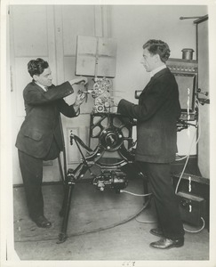 Two men set up a motion picture projector