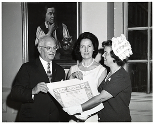 Mark Bortman, Chairman of the Civic Committee of the People-to-People Program; unidentified woman; and Mary Collins holding certificate from the Bostonian Society