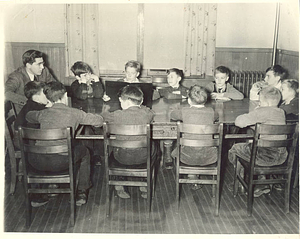Student working with class of boys (1941)