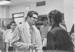 Suffolk University Vice President Donald Grunewald (1969-1972) talking with students, photograph, undated