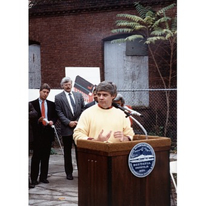 Unidentified man speaking at the podium during the Taino Tower ground breaking ceremony.