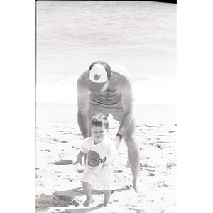 Man and toddler at the beach.