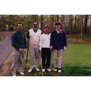 A four-man golf team standing close to a cart path at the Charlestown Boys & Girls Club Annual Golf Tournament