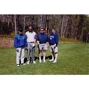 A four-man golf team smiling for the camera at the Charlestown Boys and Girls Club Annual Golf Tournament
